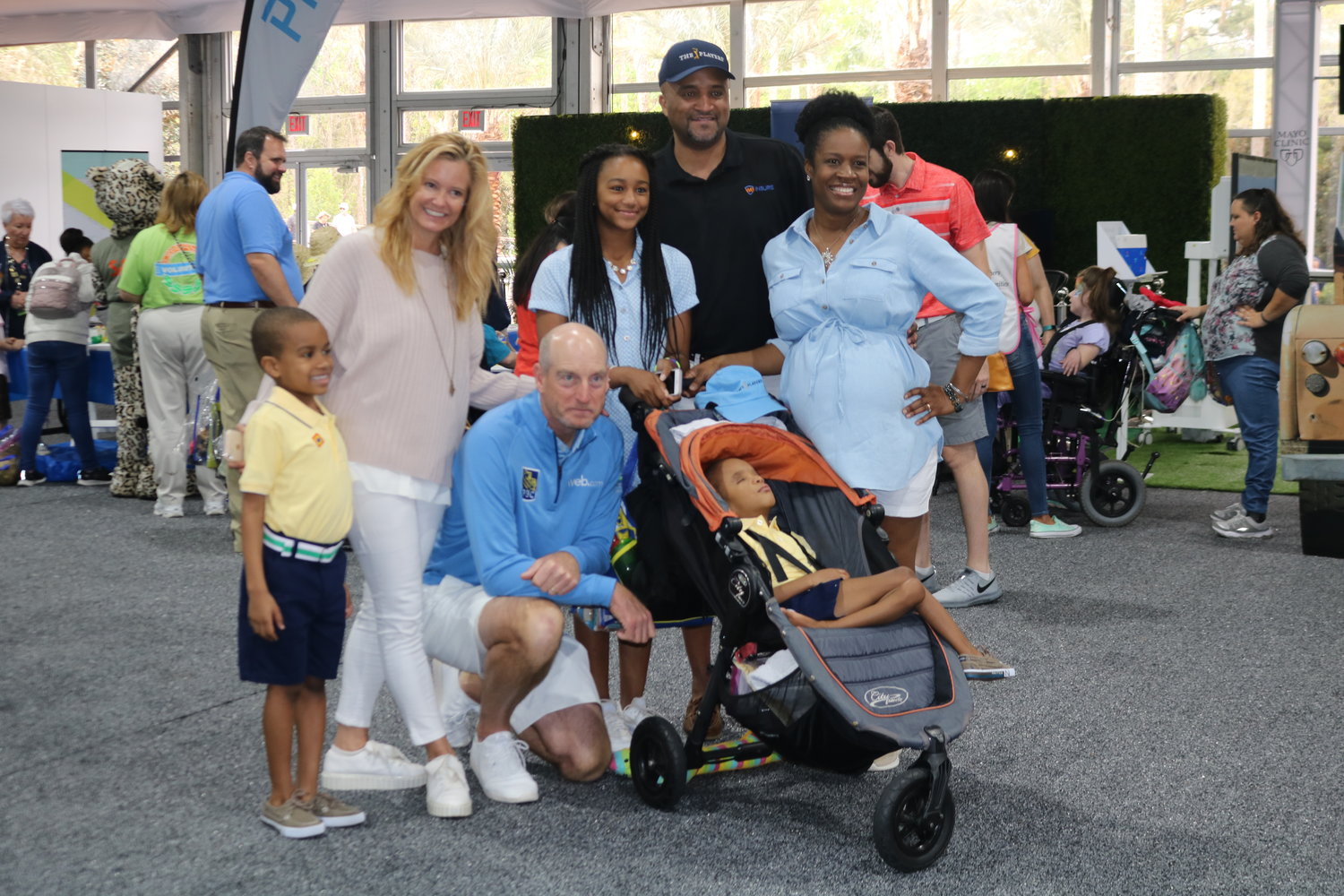 Tabitha and Jim Furyk gather with a family at “These Kids Can Safari” at THE PLAYERS on March 12.